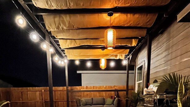 A covered outdoor patio with a fire feature, seating, and potted plants. - Lackland Air Force Base at 9 min-Brauning Lake at 25 min-3 bdr-King size-Grill (Von Ormy)