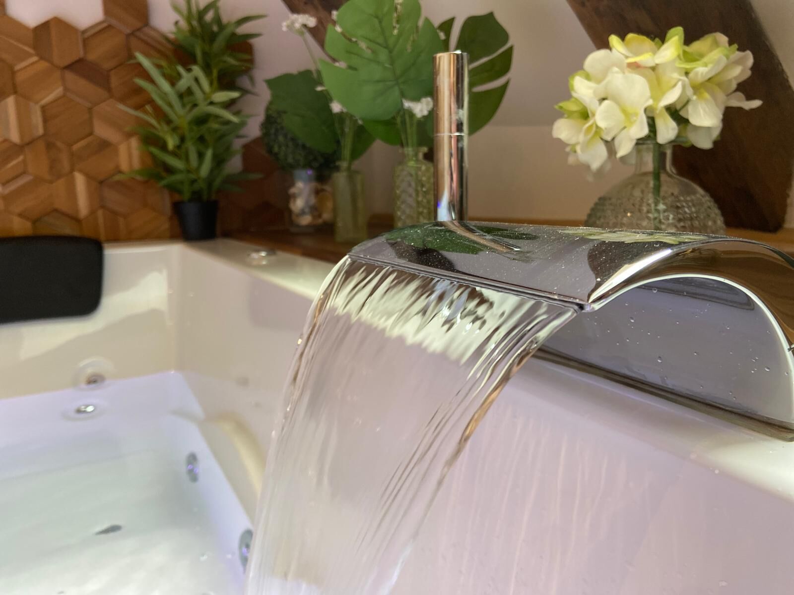 A bathroom with a modern sink and a glass shower enclosure.