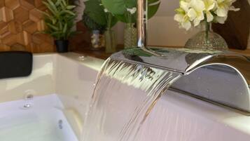 A bathroom with a modern sink and a glass shower enclosure.