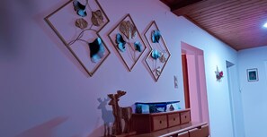 A room with a wooden dresser, a mirror, and wall-mounted decorative items. - Large apartment including Hohe Tauern Sommercard. Hiking, golf, skiing, cycling (Mittersill)