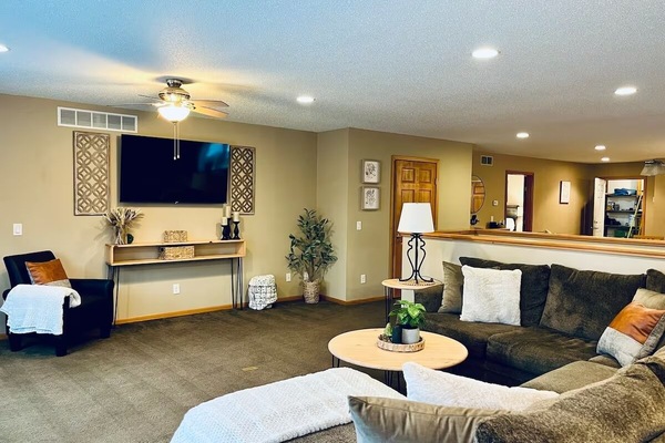 Large living room with sectional couch and large TV.