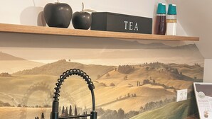 A kitchen with a modern faucet, a sink, and a wooden countertop. There is a shelf above the sink with a tea set and a laptop. - Bachgeflüster suite, incl. whirlpool, sauna (Bad Kötzting)