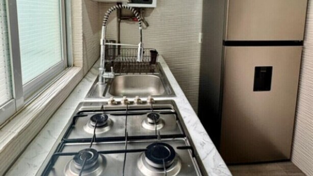 A kitchen with a gas stove, a sink, and a stainless steel refrigerator. - Nice, cozy room in Escandon CDMX (Ciudad de México)