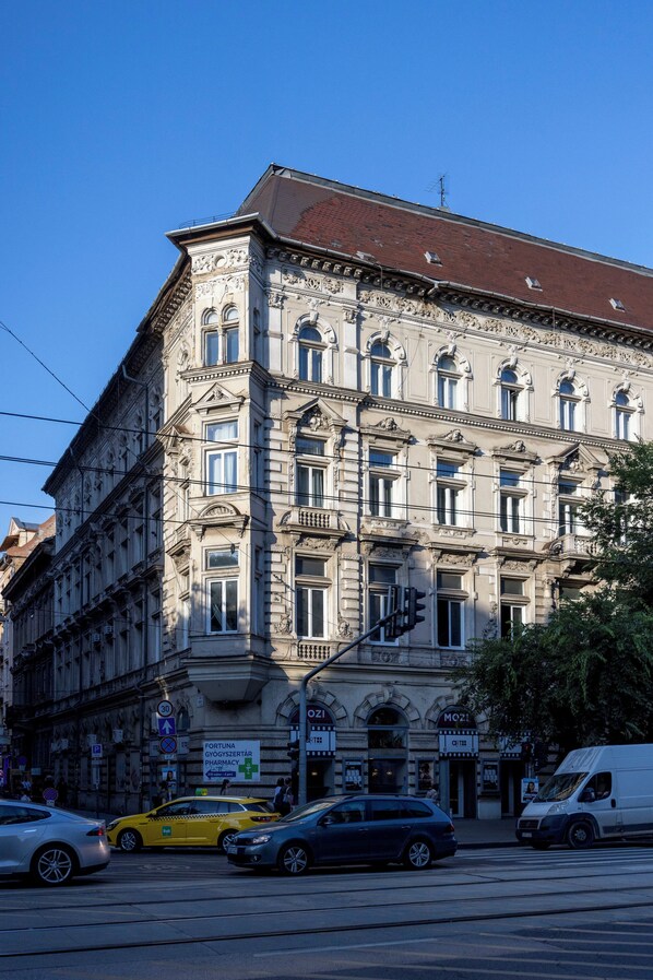A multi-story building with classical architecture, featuring ornate detailing and large windows.