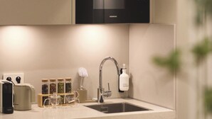 A modern kitchen with a built-in microwave, a sink, and a toaster. - Zenstay Hotel Amsterdam - Zaandam (Zaandam)
