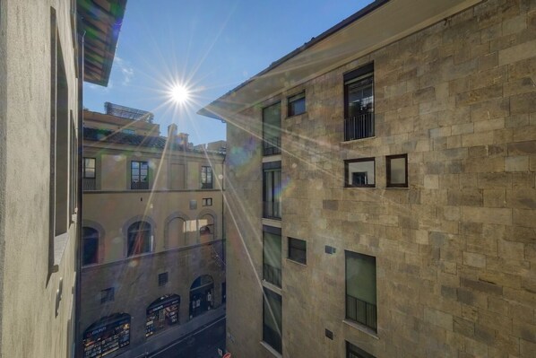 Un edificio de varios pisos con fachada de piedra y numerosas ventanas.