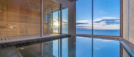 A modern infinity pool with a clear view of the ocean.