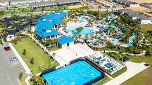An aerial view of a resort with a large swimming pool, tennis courts, and a parking lot. - Windsor Swanky (Kissimmee)