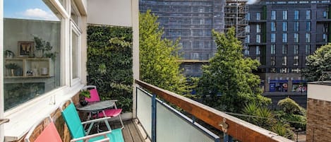 A balcony with a view of a building under construction.