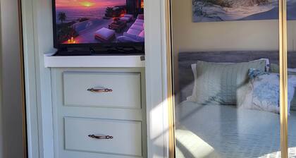 Park Model by creek and across street from beach.