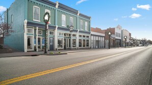 A street view of a town with a blue building with a sign that reads "The Old Town Inn". - Southern Charm and Comfort on the Bourbon Trail- Trail Suites Inn, Suite C (Lawrenceburg)