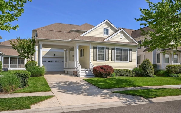A single-story house with a front porch, a garage, and a well-maintained lawn. - Bayside Home w/ Pool, Golf & Beach Shuttle (Selbyville)