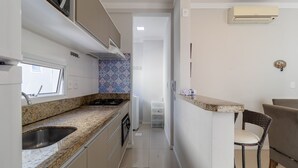 A compact kitchen with a granite countertop, a built-in sink, and a window above the sink. - 2 Bedroooms Apt w/ BBQ 500m From the Beach Pts0101 (Florianópolis)