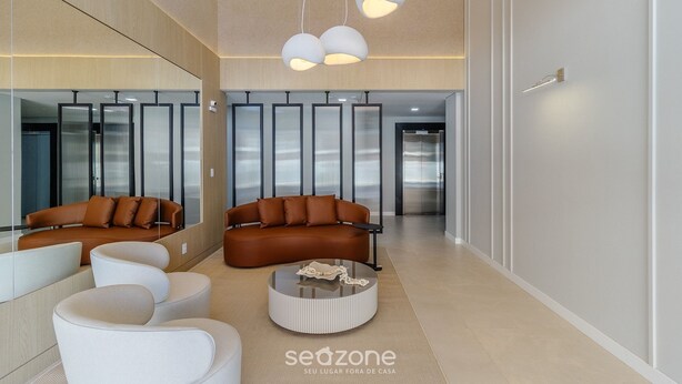 A modern interior with two sofas, a round coffee table, and pendant lighting. - Charming Apartment 210m From Jurere Beach Psj0304 (Florianópolis)