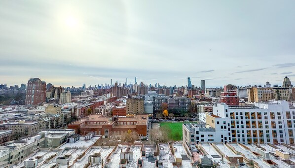 A cityscape with a mix of high-rise and low-rise buildings, a variety of architectural styles, and a clear sky.