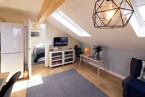 Superior Cottage, Ensuite (The Studio Cheddar) | Living area | LCD TV, DVD player, books, video library