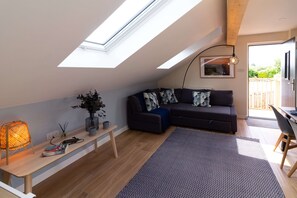 Superior Cottage, Ensuite (The Studio Cheddar) | Living area | LCD TV, DVD player, books, video library