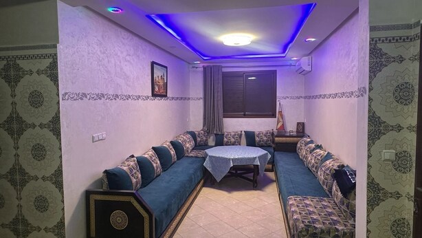 A room with a sofa set, a small table, and patterned walls. - Residence Ennasr 3 Hay Essalam (Hay Essalam)