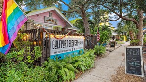 A restaurant named Gulfport Brewery & Eatery with a signboard, a rainbow flag, and a chalkboard menu. - GUEST HOUSE w/ PRIVATE ENTRANCE & PATIO for rent in Gulfport, FL (Gulfport)