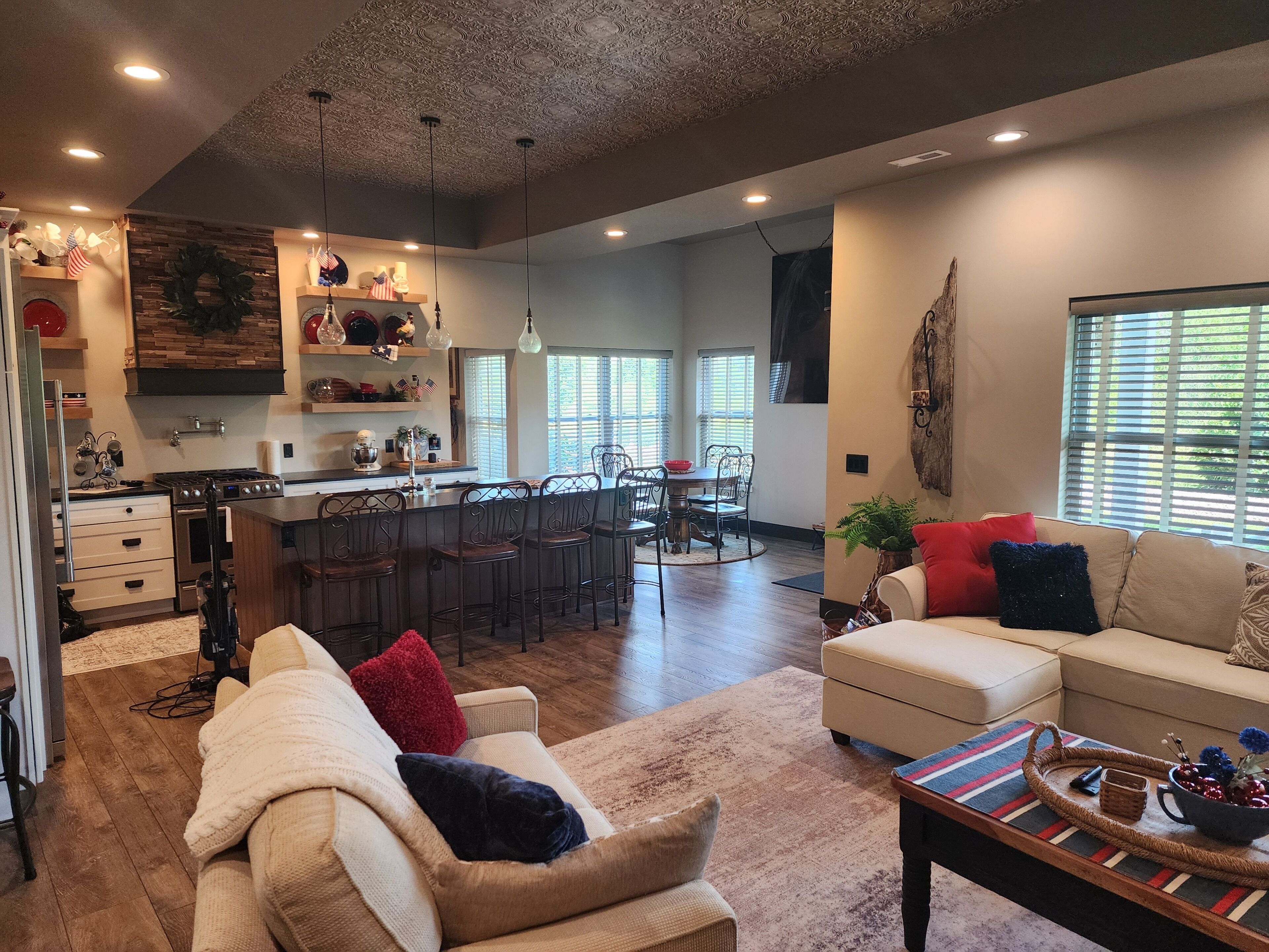 A spacious living area with a kitchen, dining space, and a cozy seating area.