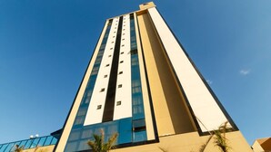 A tall hotel building with a modern design, featuring a prominent vertical structure and large windows. - Apartments in the Turquesa Building - Balneario Picarras - RTS (Picarras)