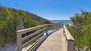 A wooden boardwalk leading to a beach with a sign indicating private use by Rosemary Beach owners. - Golf Cart, Bikes, Game Room, Walk to Big Chill, Minutes from Seaside & Rosemary (Santa Rosa Beach)