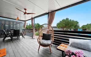 A covered outdoor area with a ceiling fan, wicker chairs, a table, and a view of trees and a pool. - Awesome home in Pirovac with swimming pool (Pirovac)