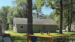 A backyard with a fire pit, picnic table, and outdoor seating. - Charming 2-bedroom home in Hackensack. Enjoy during the summer and winter. (Hackensack)
