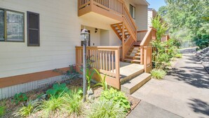 A two-story building with a wooden balcony and a staircase leading to the upper floor.