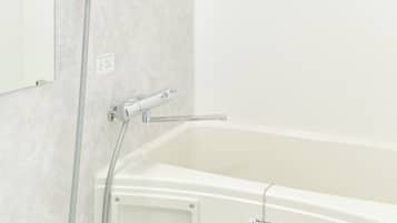 Combined shower/bathtub, hair dryer, slippers, towels