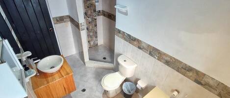A compact bathroom with a toilet, sink, and bathtub.