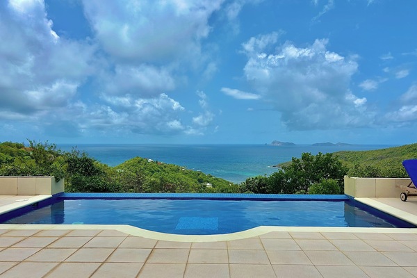 Gorgeous pool side area with multiple seating options, overlooking Spring Estate