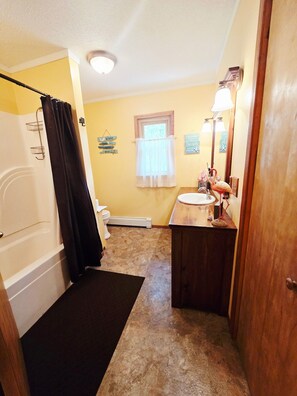 Shower, hair dryer, towels, toilet paper