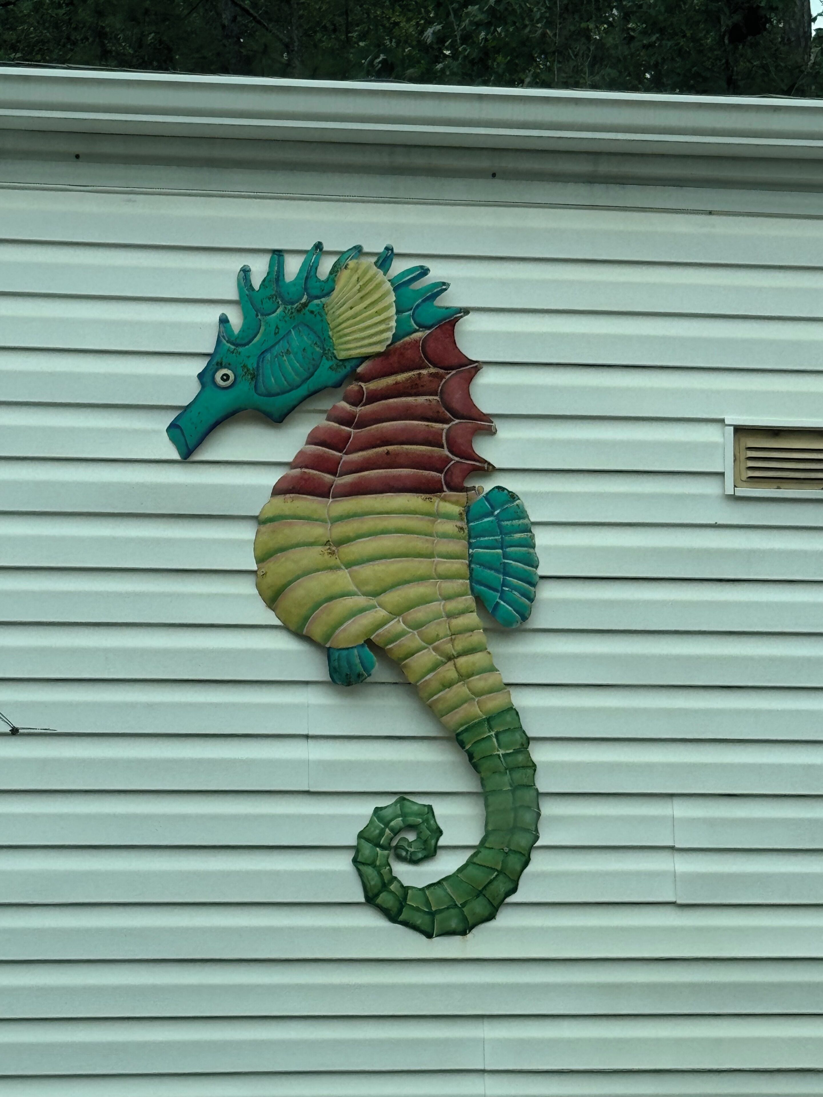 A seahorse decoration on a house's exterior wall.