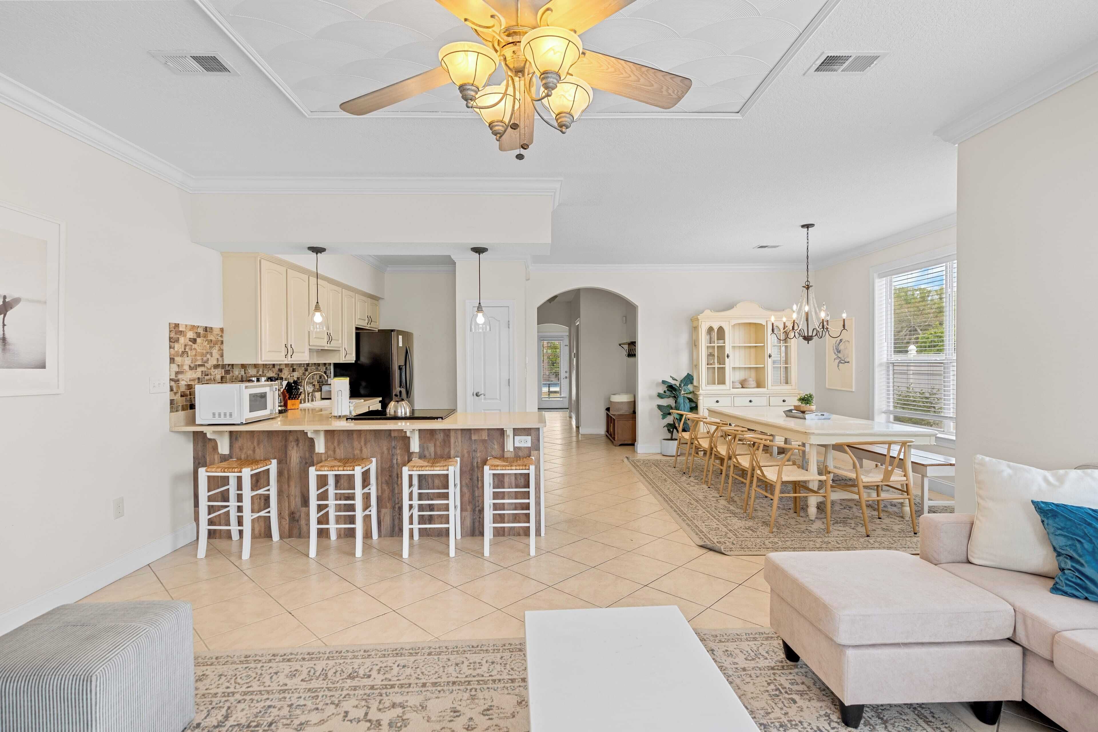 A spacious living area with a kitchen, dining area, and a large window.