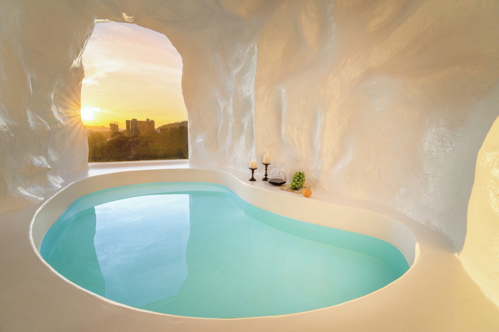 An ice bath with a view of a cityscape at sunset.
