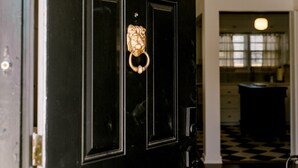 A black door with a gold knocker and a keyhole. - Cute Bungalow in Central Lubbock (Lubbock)