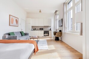A modern apartment with a large bed, a sofa, a dining area, and a kitchen. - Blueground | Seebach, washer, nr Zürich Zoo (Zurich)