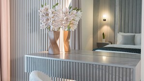 A modern bedroom with a bed, a nightstand, and a vase with white flowers on a bedside table. - 1BDR Premium Yas Island - Ferrari, Sea World, F1 (Abu Dhabi)