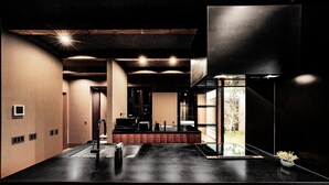 A modern kitchen with a black countertop, wooden cabinets, and a view of the outdoors. - A private villa where you can step away from your daily life and savor "extra... (karatushi watada honmura)