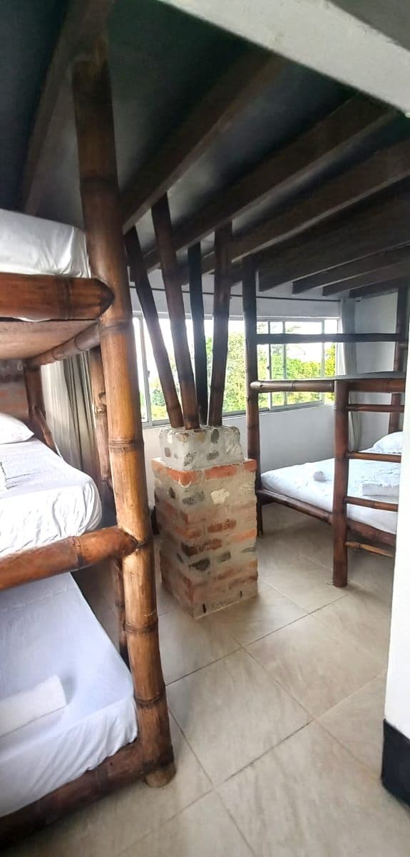 A room with bunk beds, a brick structure, and a tiled floor.