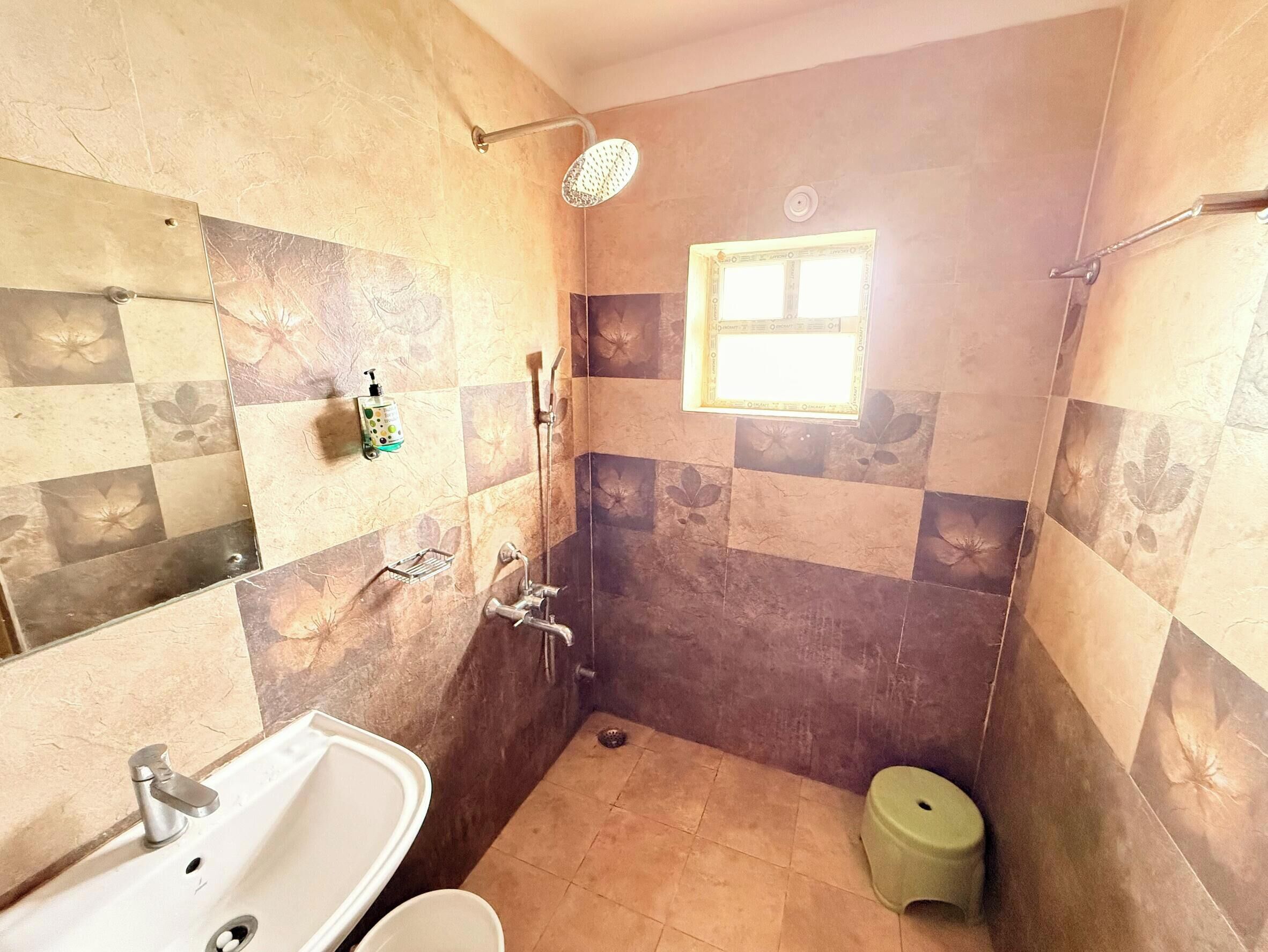 A bathroom with a shower, sink, and toilet.