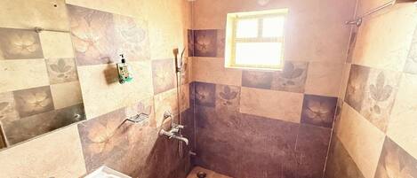 A bathroom with a shower, sink, and toilet.