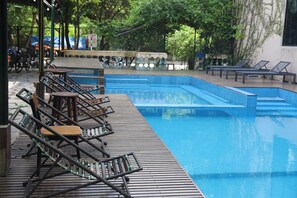 A swimming pool with lounge chairs and a wooden deck. - Tam Coc Lion Kings Hotel & Resort Ninh Binh (Hoa Lu)