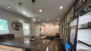 A modern kitchen with a central island, built-in cabinetry, and pendant lighting.