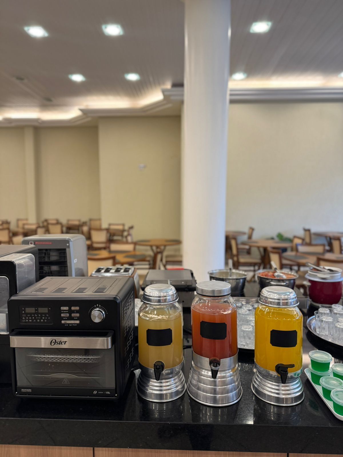 A self-service beverage station with various drink dispensers and a coffee machine.