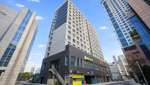 A modern high-rise building with a prominent entrance and signage. - ALL STAY Myeongdong (Seoul)