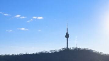 A tower on a hill with a clear sky.