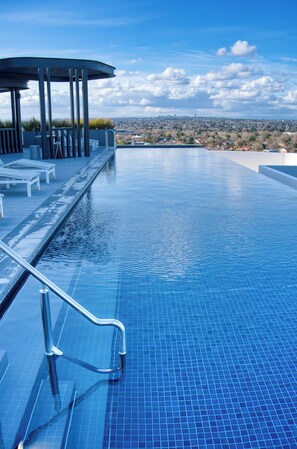 An infinity pool with a clear view of the city skyline in the background. - Park Avenue - Carnegie (Carnegie)