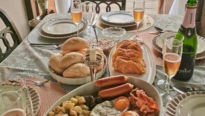 A table set for a meal with various dishes, glasses of wine, and a bottle of champagne. - 4000Dao-A Hilltop Hideaway Experience  (Mae Chan)